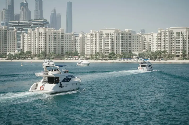Yachts cruising past Palm Jumeirah residences